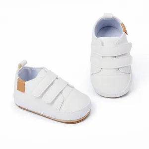 Detail view of white baby walker shoes featuring functional double hook-and-loop straps