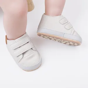 Close-up of white soft-soled baby walking shoes with anti-slip patterned soles
