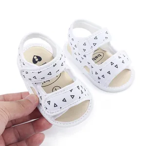 Close-up view of white baby summer sandals with triangle print and soft anti-slip fabric sole