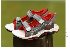 Detailed side view of boys' sporty sandals with red mesh and gray straps.