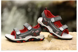 Detailed view of red and grey boys' sandals with breathable mesh and Velcro straps