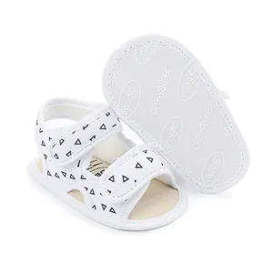 Detail view of white baby pre-walker sandals with black triangle pattern and soft anti-slip sole