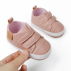 Detailed close-up of pink infant walking shoes featuring secure triple Velcro strap design