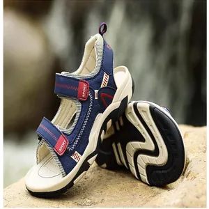 Detail view of navy blue boys sports sandals with durable non-slip rubber soles.