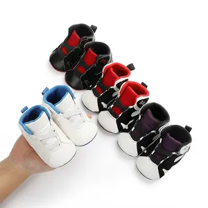 Close-up of various colorful soft-soled baby basketball sneakers on white background.