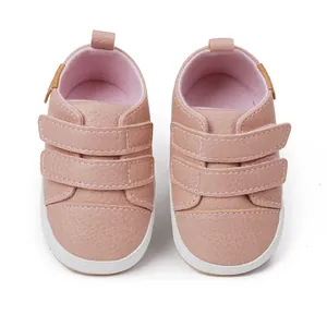 Detailed view of pink faux leather baby walking shoes featuring dual adjustable straps