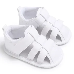 Close-up view of white canvas closed-toe baby sandals featuring a soft anti-slip sole