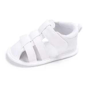 Detailed side view of white baby closed-toe walker sandals with soft anti-slip soles