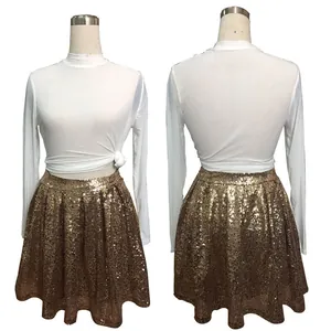 Fashionable women's golden sequin pleated mini skirt with white long sleeve top outfit