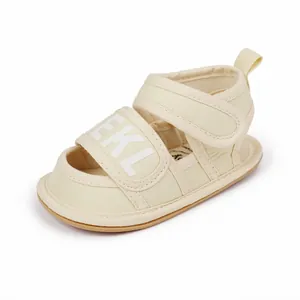 Detail view of beige infant canvas summer sandals with BEKL logo and Velcro straps