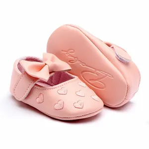 Detailed view of pink baby girl soft sole walking shoes with heart embroidery and bow