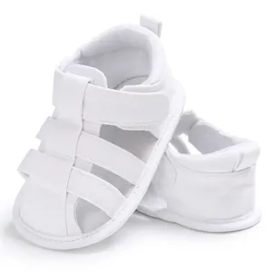 Close-up of white infant closed-toe sandals with soft anti-slip soles for baby boys.