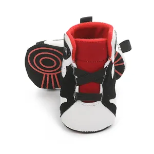 Close-up detail of red and black soft sole infant basketball walking shoes