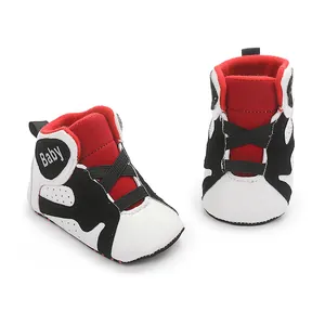 Close-up of red, white, and black soft-sole baby basketball sneakers for walking