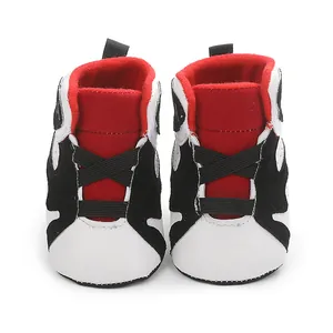 Front view detail of high-top soft-sole baby basketball sneakers in red and black colors