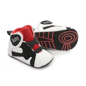 Detail view of baby basketball walking shoes with soft non-slip soles in black red and white