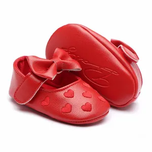 Close-up detail of red soft-sole baby girl princess walking shoes with heart embroidery