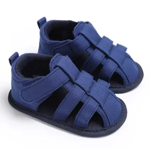 Close-up view of navy blue baby boy sandals with closed-toe design and soft anti-slip soles