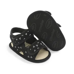 Close-up of black baby pre-walker sandals with white triangle pattern and non-slip sole