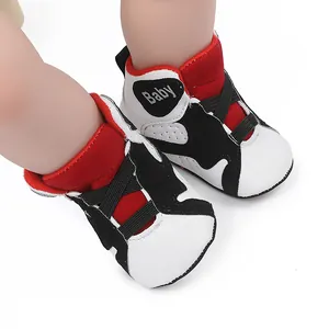 Close-up of stylish red, white and black baby basketball sneakers with soft non-slip soles