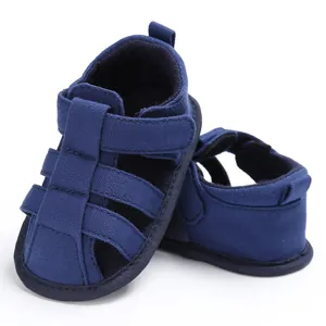 Detailed view of navy blue canvas infant sandals featuring soft anti-slip walker soles