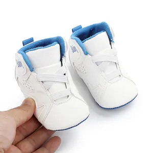 Close-up of white baby basketball shoes with blue lining and soft anti-slip soles for infants