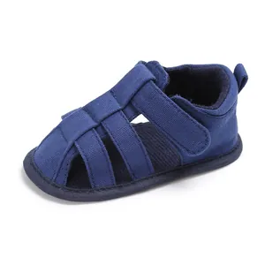 Detailed side view of navy blue soft-sole infant boys' closed-toe walking sandals