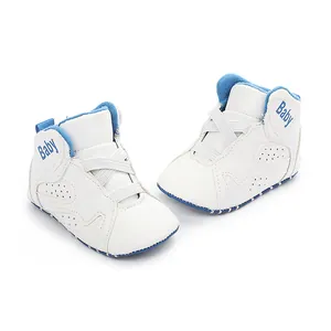 Close-up of white baby basketball shoes with blue trim and soft anti-slip soles