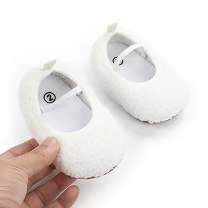 Macro detail view of soft white fleece baby pre-walker shoes with flexible elastic strap
