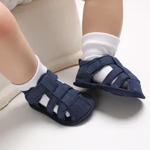 Detailed view of navy denim baby boy sandals with soft anti-slip soles for toddler walking