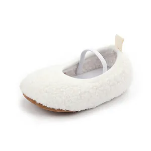 Close-up of a white fuzzy baby walking shoe with a soft elastic strap and brown sole.