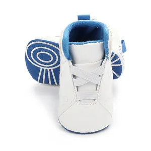 Detail view of baby basketball walking shoes featuring a non-slip blue soft sole and white upper.