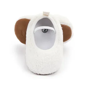 Close-up detail of soft white fluffy fleece baby walking shoes with elastic strap for comfort