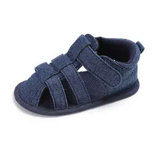 Close-up of navy blue denim baby boy closed-toe sandals with soft anti-slip soles.
