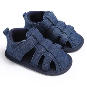 Detailed view of blue denim baby boy closed-toe sandals with soft non-slip soles for walking