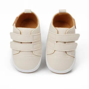 Top view of cream baby walker shoes with double velcro straps and soft white soles