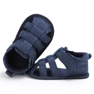 Detail view of navy blue denim baby sandals with soft anti-slip soles for toddlers.
