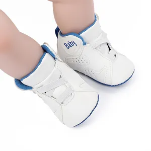 White infant basketball shoes with soft sole and blue trim details.