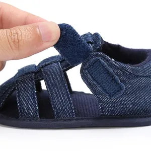 Detailed view of the convenient hook-and-loop closure on baby boy denim sandals.