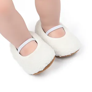 Detailed view of white plush baby walking shoes with elastic straps on doll legs