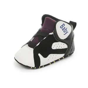 Detailed view of black and white baby basketball shoes with soft sole for infants.