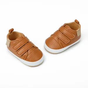 Detailed macro view of brown faux leather baby walking shoes with triple Velcro straps.