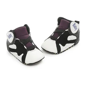 Detailed view of stylish black and white baby basketball shoes with soft anti-slip rubber soles