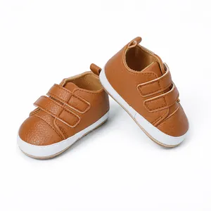Detailed view of brown baby walker shoes with white soles and double velcro straps