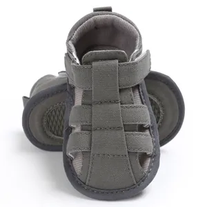 Macro detail view of olive green canvas soft-soled baby sandals for infant boys walking