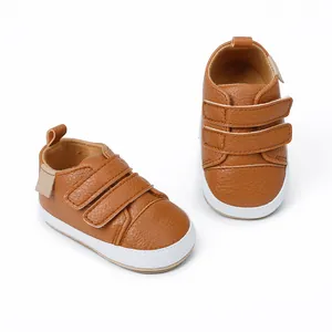 Detailed view of brown baby walker shoes with dual velcro straps and leather texture