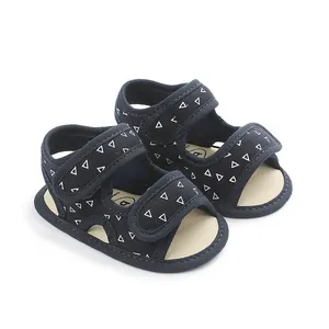 Detailed close-up view of navy baby sandals with white triangle pattern and soft soles
