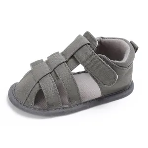 Close-up of olive green baby boy sandals with soft soles for pre-walking safety.