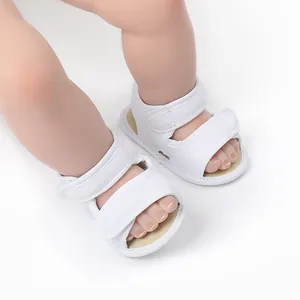 Macro detail of white breathable mesh baby sandals with secure double velcro straps