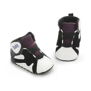 Detailed view of black and white high-top baby basketball shoes with soft non-slip soles.